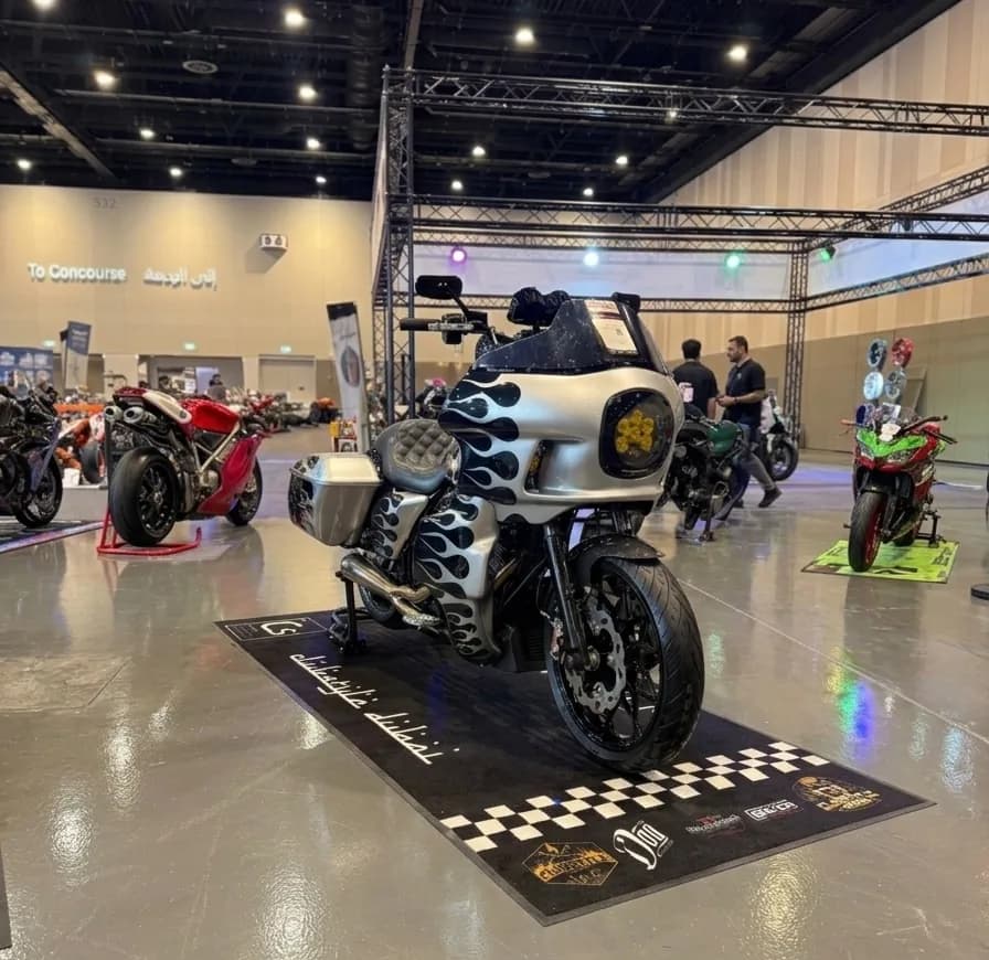 Silver flame-painted custom clubstyle Road Glide on a Clubstyle Dubai mat at a Dubai bike show